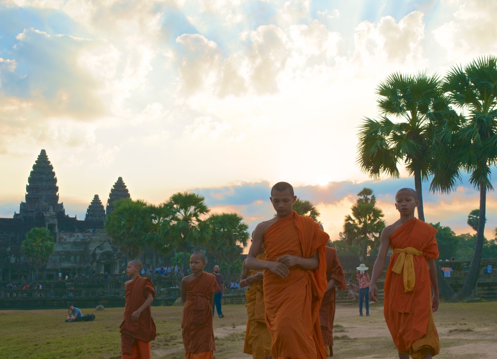 A young group of Buddhists at sunrise at Angkor Wat